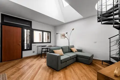a living room with a couch and a table at The Spiral Way - Trastevere apartment with large private terrace in Rome