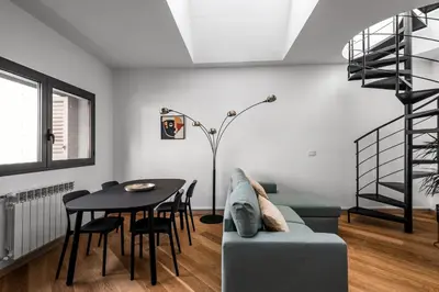a living room with a couch and a table at The Spiral Way - Trastevere apartment with large private terrace in Rome