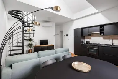 a living room with a couch and a table at The Spiral Way - Trastevere apartment with large private terrace in Rome