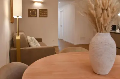 a living room with a table with a vase on it at Maralf Urban Suites in Rome