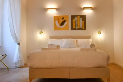 a bedroom with a bed with two towels on it at Maralf Urban Suites in Rome