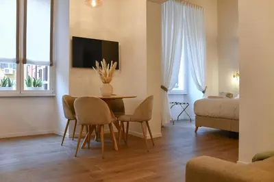 a living room with a table and chairs at Maralf Urban Suites in Rome