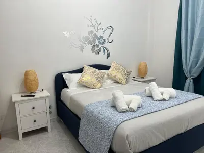 a bedroom with a bed with two pillows on it at Casa Romi in Rome