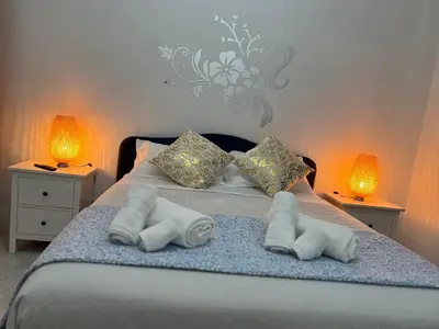 a bed with towels on it with two lamps at Casa Romi in Rome