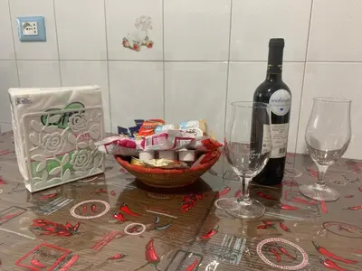 a table with a bottle of wine and two glasses at Casa Romi in Rome
