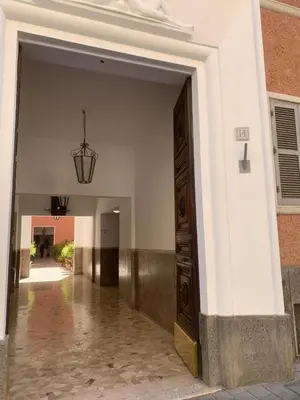 a hallway of a building with a large door at Casa Romi in Rome