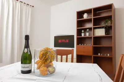 a bottle of champagne and some fruit on a table at Appartamento Gemelli - Val Favara Apartment in Rome