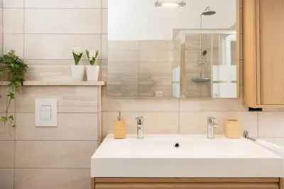 a bathroom with a white sink and a mirror at Appartamento Gemelli - Val Favara Apartment in Rome