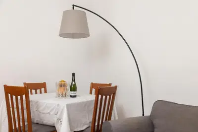 a table with a bottle of wine and a lamp at Appartamento Gemelli - Val Favara Apartment in Rome