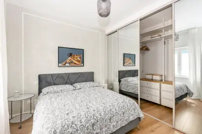 a white bedroom with a bed and a mirror at Vatican Manu Home in Rome