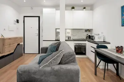 a living room with a couch and a kitchen at Vatican Manu Home in Rome