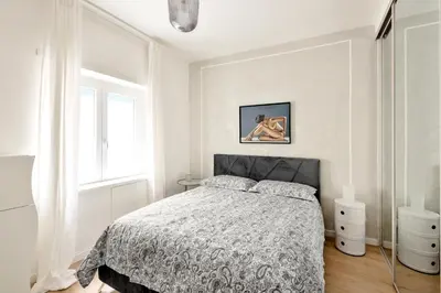 a white bedroom with a bed and a window at Vatican Manu Home in Rome