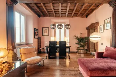 a living room with a table and chairs at Charme Apt in Piazza Monti in Rome
