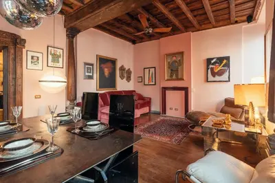 a living room with a table and a couch at Charme Apt in Piazza Monti in Rome