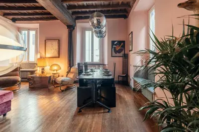 a living room with a table and a potted plant at Charme Apt in Piazza Monti in Rome
