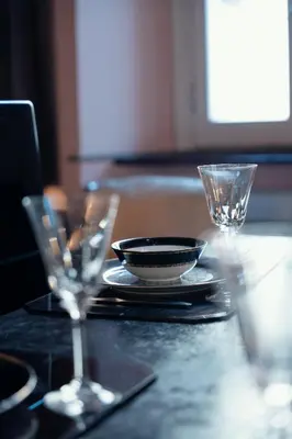 a table with a plate and glasses on a table at Charme Apt in Piazza Monti in Rome