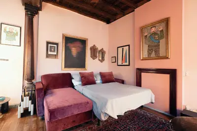 a bedroom with a bed and a chair at Charme Apt in Piazza Monti in Rome