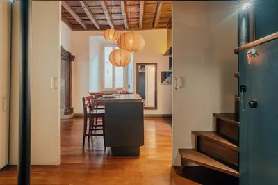 a kitchen and dining room with a sink and a table at Charme Apt in Piazza Monti in Rome