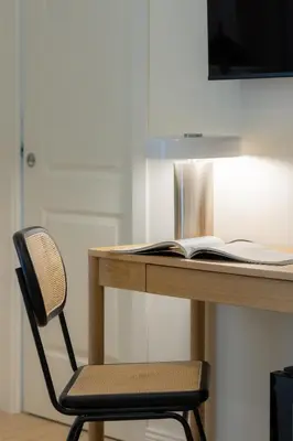 a desk with a chair and an open book at Giano Vatican Suites - Metro Cipro in Rome