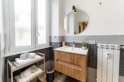 a bathroom with a sink and a mirror at Giano Vatican Suites - Metro Cipro in Rome