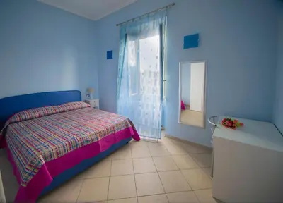 a blue bedroom with a bed and a window at ad duas lauros in Rome