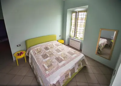 a bedroom with a bed and a mirror at ad duas lauros in Rome
