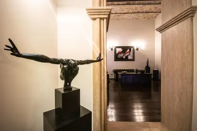a statue of a woman on a stand in a hallway at Reco Luxury Suite Rome in Rome