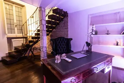 a room with a desk and a spiral staircase at Reco Luxury Suite Rome in Rome