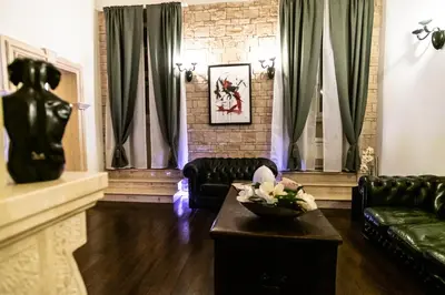 a living room with black leather couches and a table at Reco Luxury Suite Rome in Rome
