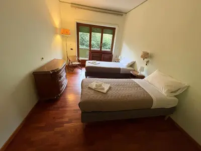 a hotel room with two beds and a window at Apartment in Trastevere 41 in Rome