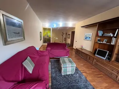 a living room with a purple couch and a tv at Apartment in Trastevere 41 in Rome