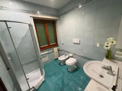 a bathroom with a shower and a toilet and a sink at Apartment in Trastevere 41 in Rome