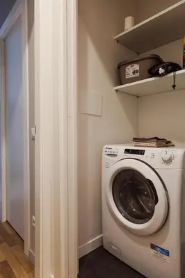 a laundry room with a washer and dryer at Pinturicchio's Rooms at Flaminio in Rome