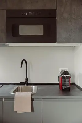 a kitchen counter with a sink and a microwave at Pinturicchio's Rooms at Flaminio in Rome