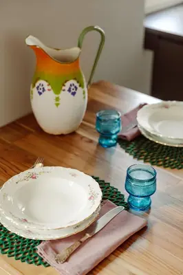 a wooden table with plates and a vase on it at Pinturicchio's Rooms at Flaminio in Rome