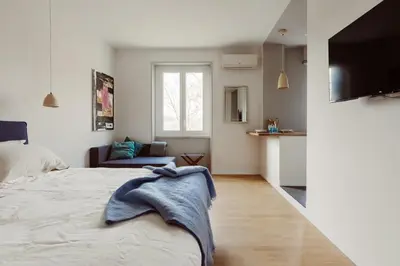 a bedroom with a bed and a living room at Pinturicchio's Rooms at Flaminio in Rome