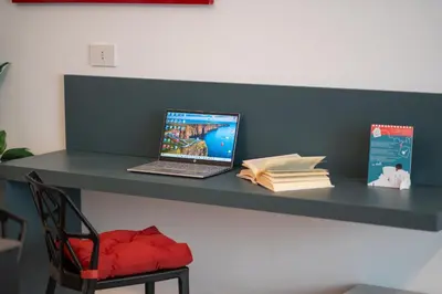 a laptop computer sitting on a desk with a chair at Luxury Sweet Home Labicana in Rome