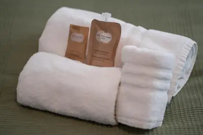 a pair of white towels with two candles in them at Luxury Sweet Home Labicana in Rome