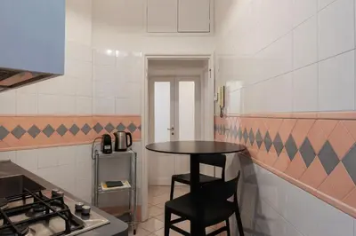 a small kitchen with a table and a stove at GuestHost - Zia Pina's Apartment in Rome