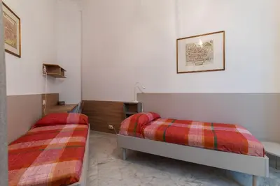 a room with two beds in a room at GuestHost - Zia Pina's Apartment in Rome