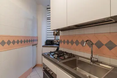 a kitchen with a sink and a stove at GuestHost - Zia Pina's Apartment in Rome
