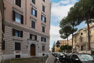 a building on the side of a street with parked cars at GuestHost - Zia Pina's Apartment in Rome