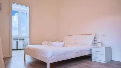 a white bedroom with a white bed and a window at Collection39 Scipioni Luxury Penthouse in Rome
