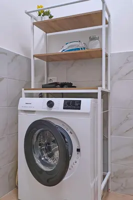 a washing machine in a room with a shelf at Collection39 Scipioni Luxury Penthouse in Rome