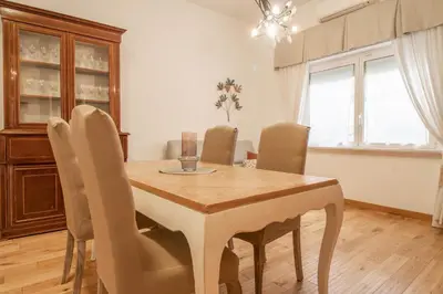 a dining room with a wooden table and chairs at A casa di Carlo Roma Vaticano in Rome