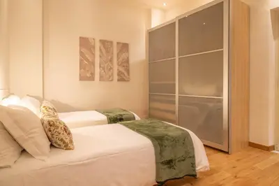 a bedroom with two beds and a glass wall at A casa di Carlo Roma Vaticano in Rome