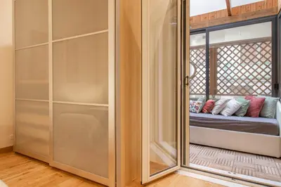 a sliding glass door in a room with a couch at A casa di Carlo Roma Vaticano in Rome