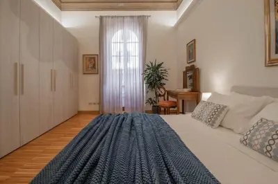 a bedroom with a large bed and a window at Casa Nicalandro Roma Centro in Rome