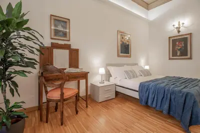a bedroom with a bed and a desk and a chair at Casa Nicalandro Roma Centro in Rome