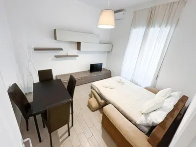 a small room with a table and a bed at Casa Polly in Rome
